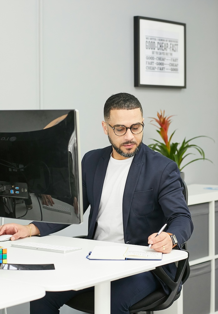 A man reviewing notes at an office desk